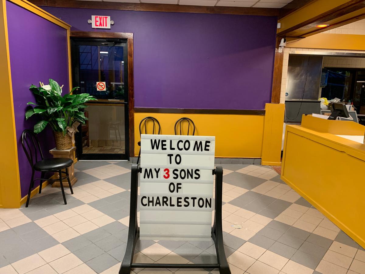 This is a sign in the middle of a restaurant that says Welcome to My Three Sons.